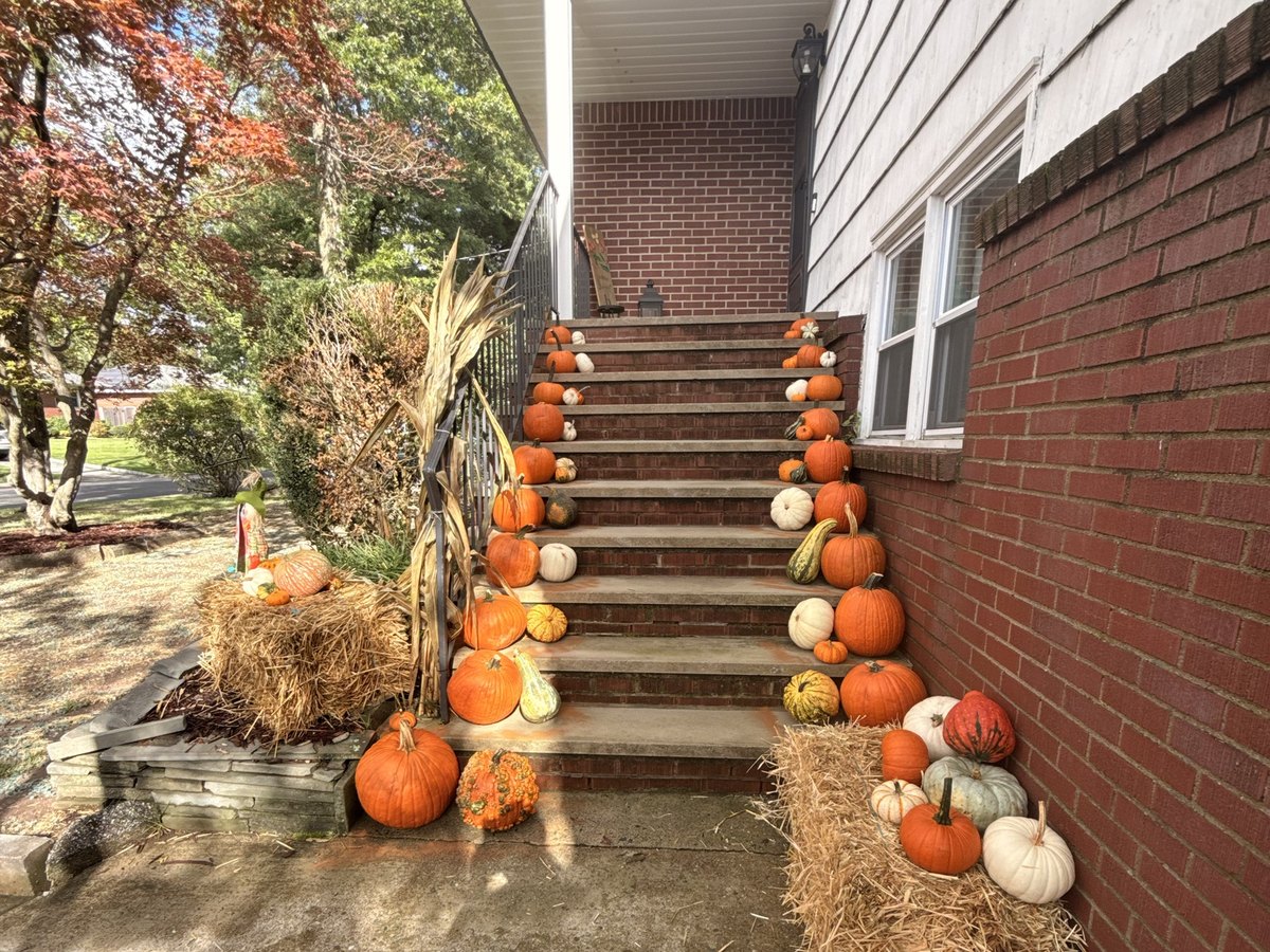 Real staircase pumpkin display in Hillsdale NJ, The Classic package styled by Pascack Porches with straw bales, cornstalks, and mixed pumpkins