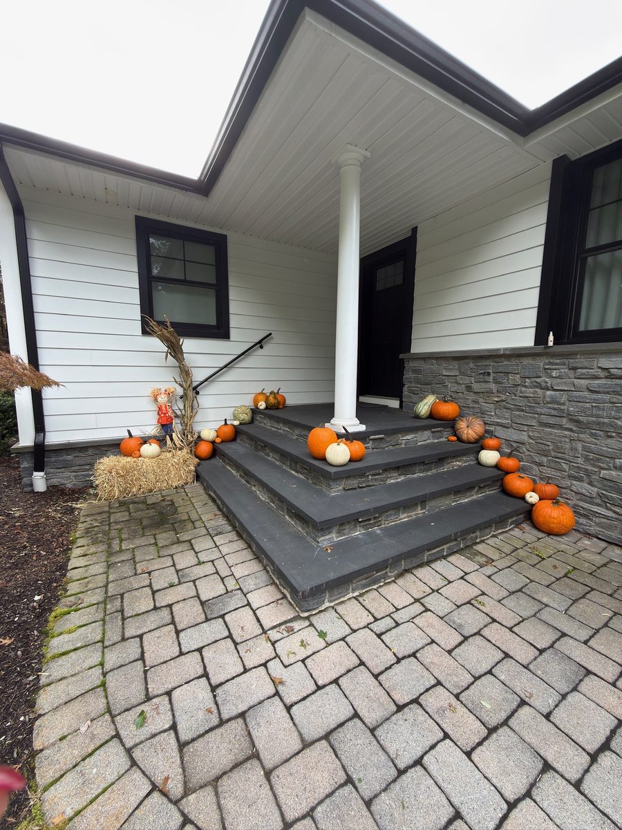 Real fall pumpkin porch display styled by Pascack Porches on stone steps in the Pascack Valley